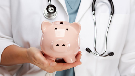 A doctor holding a piggy bank